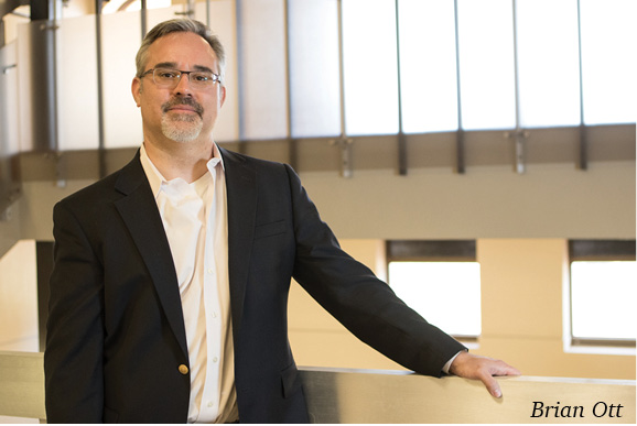 Dr. Brian Ott standing next to stairs