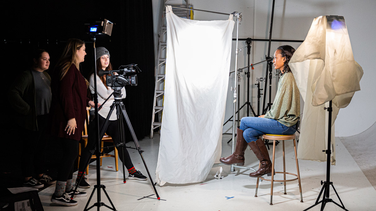 Students taking photos in lighting studio