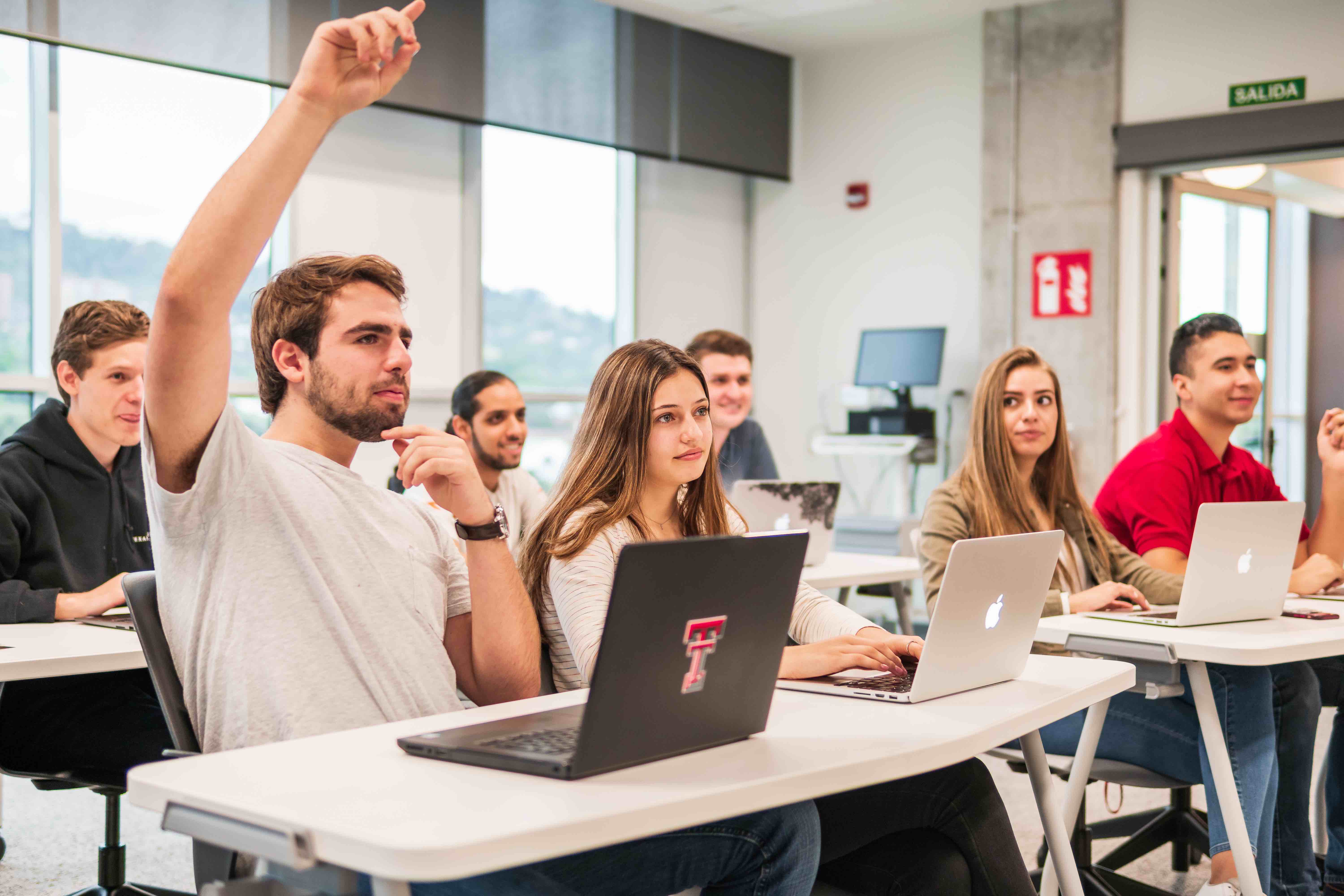 Students in class raising their hand