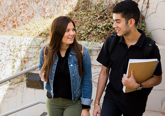 two Texas Tech students walking up a flight of stairs