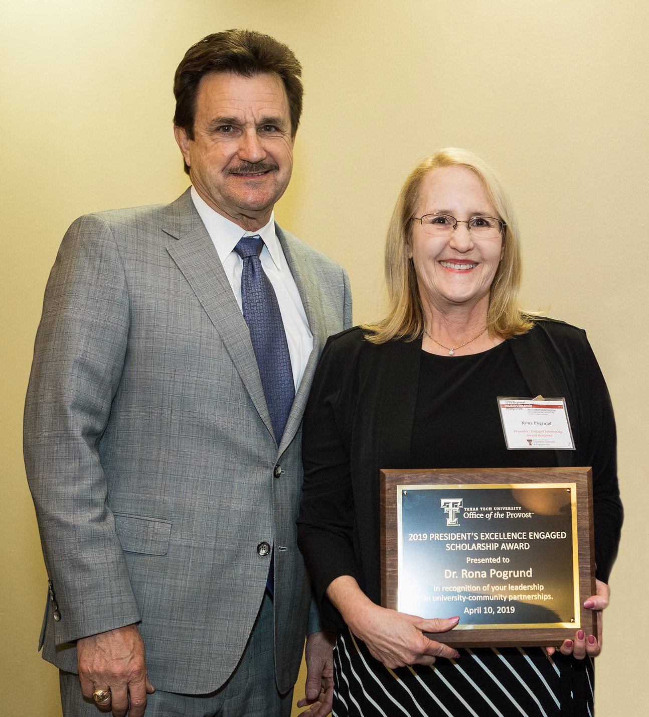 Texas Tech President Lawrence Schovanec presenting Dr. Rona Pogrund with the President's Excellence in Engaged Scholarship Award in 2019