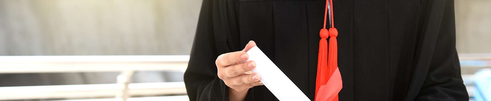 Photo of a graduate holding a diploma