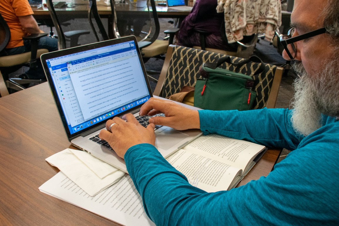 Dr. Saldana writing at the LEWA Summer Intensive 2022