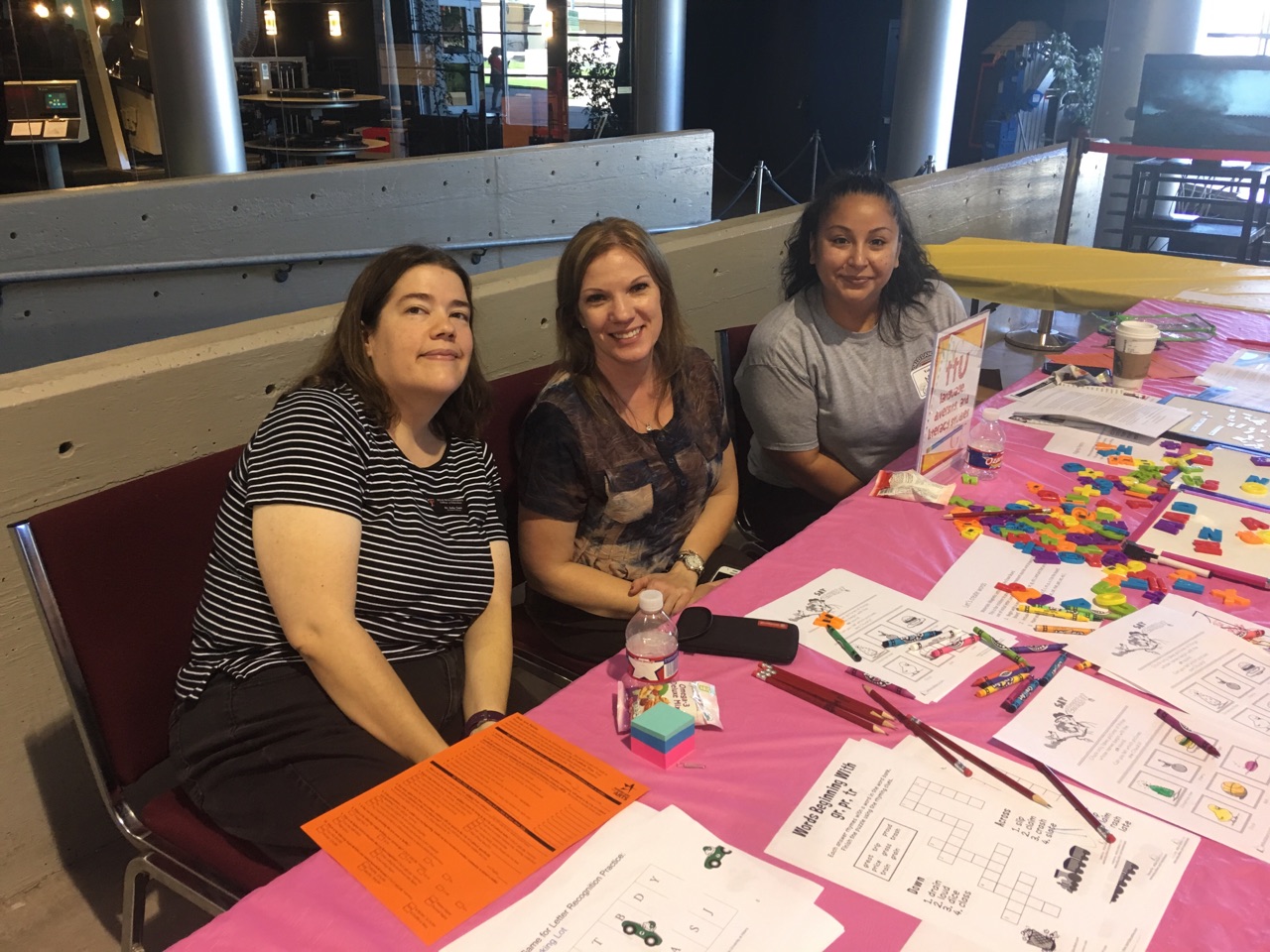 Faculty at literacy fair with reading activities