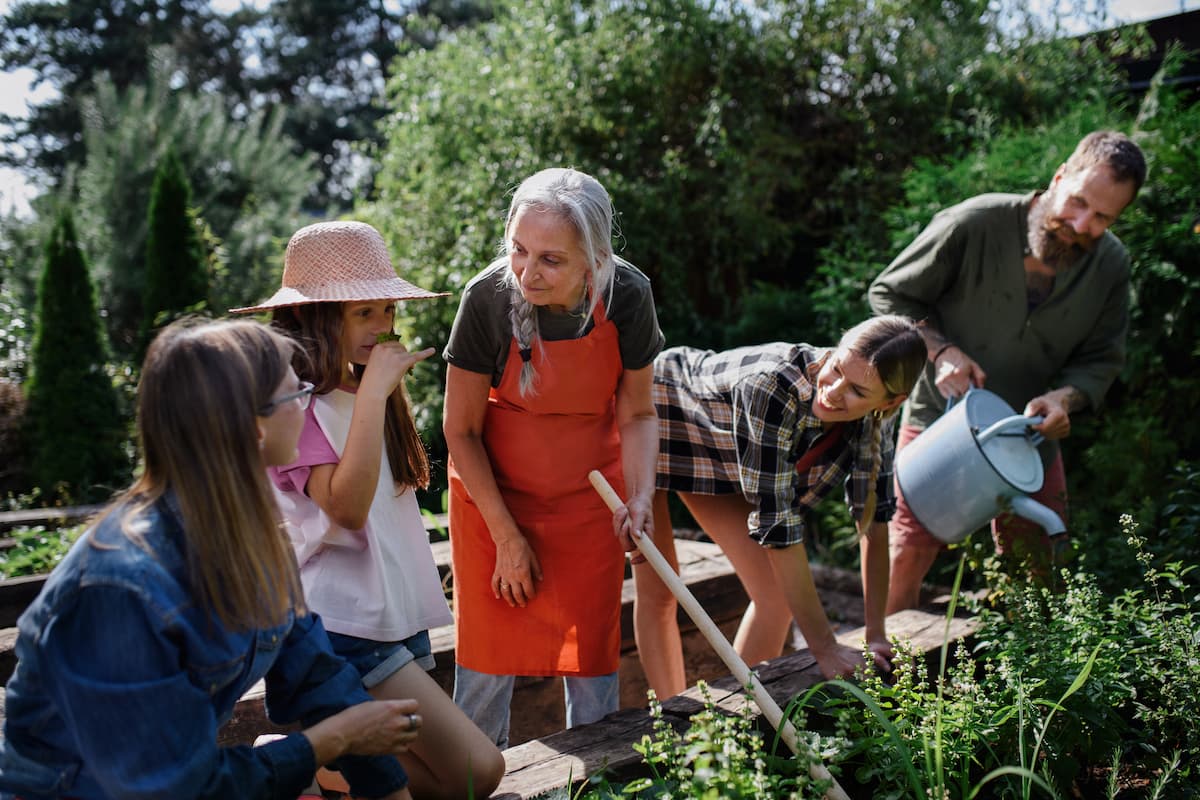 Multigenerational family working together in a garden.