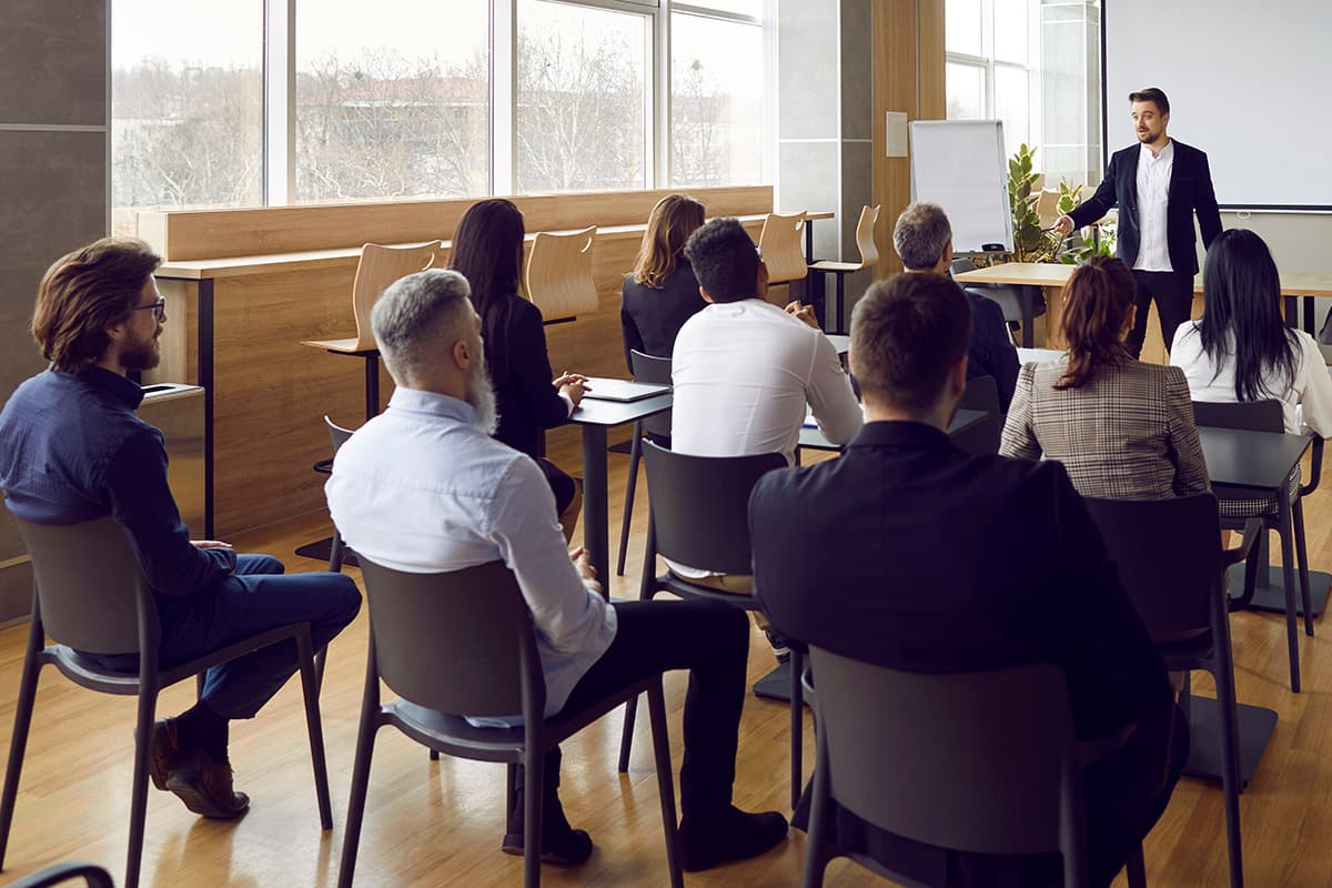 A group of school administrators meet for a presentation in a conference room.