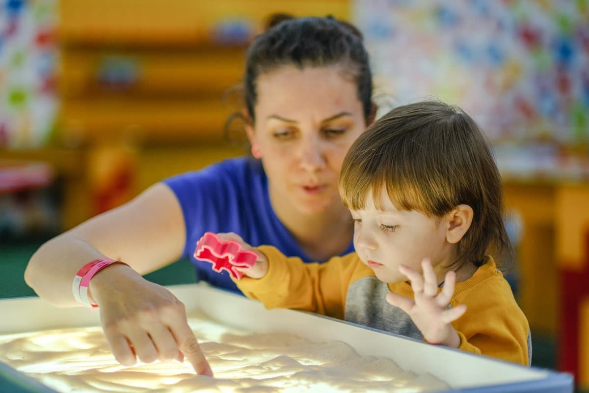 Instructor and student with sand table