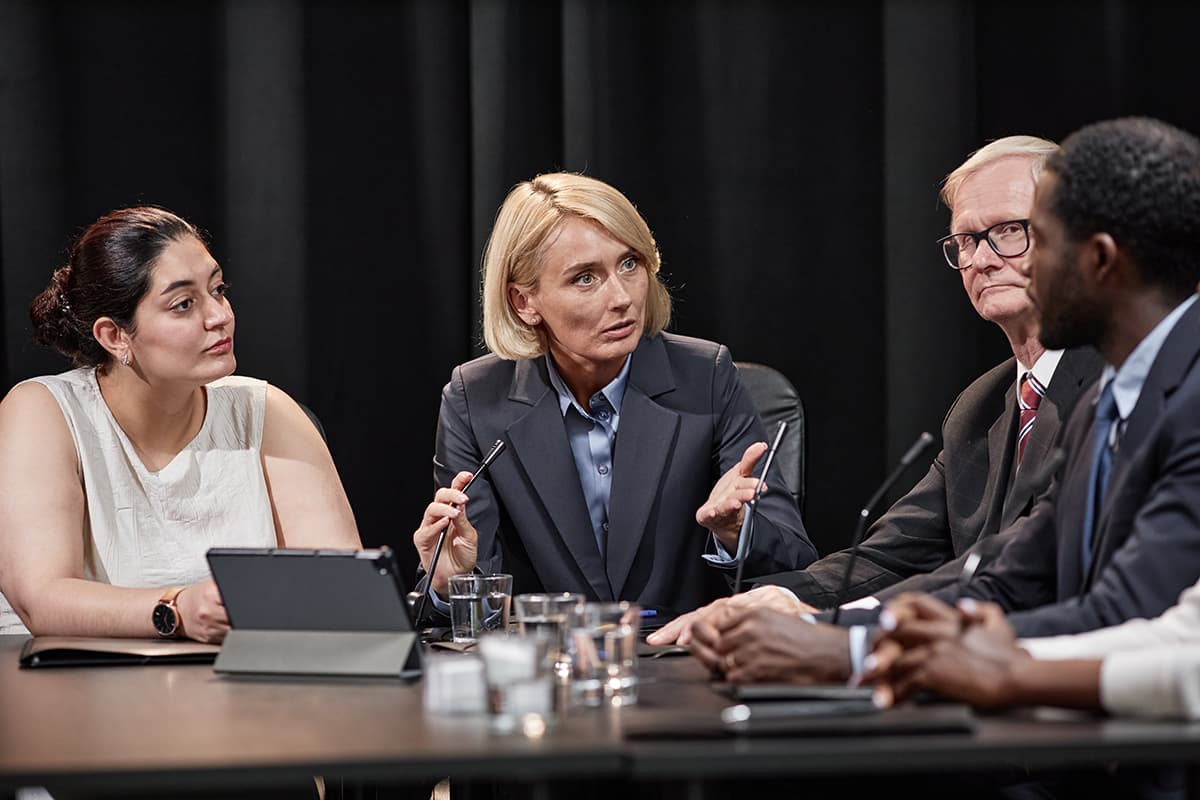 Group of policymakers debating in front of microphones