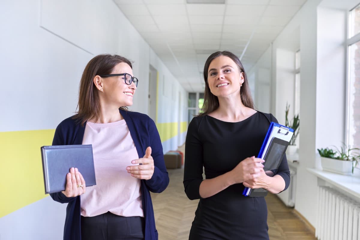 Two school psychologists walking down a school hallway