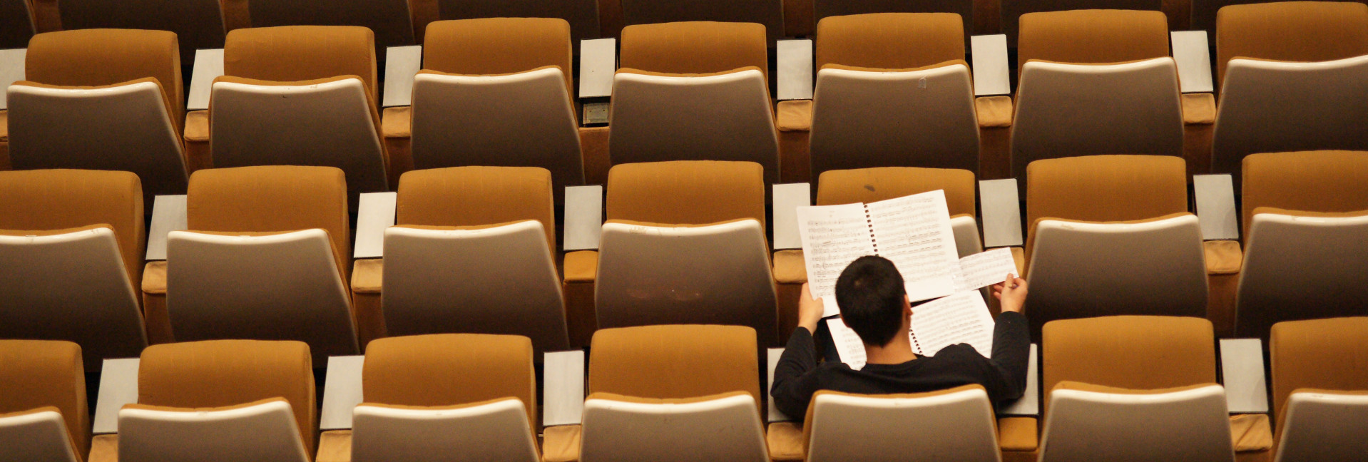Overhead photo of a single student in a lecture hall