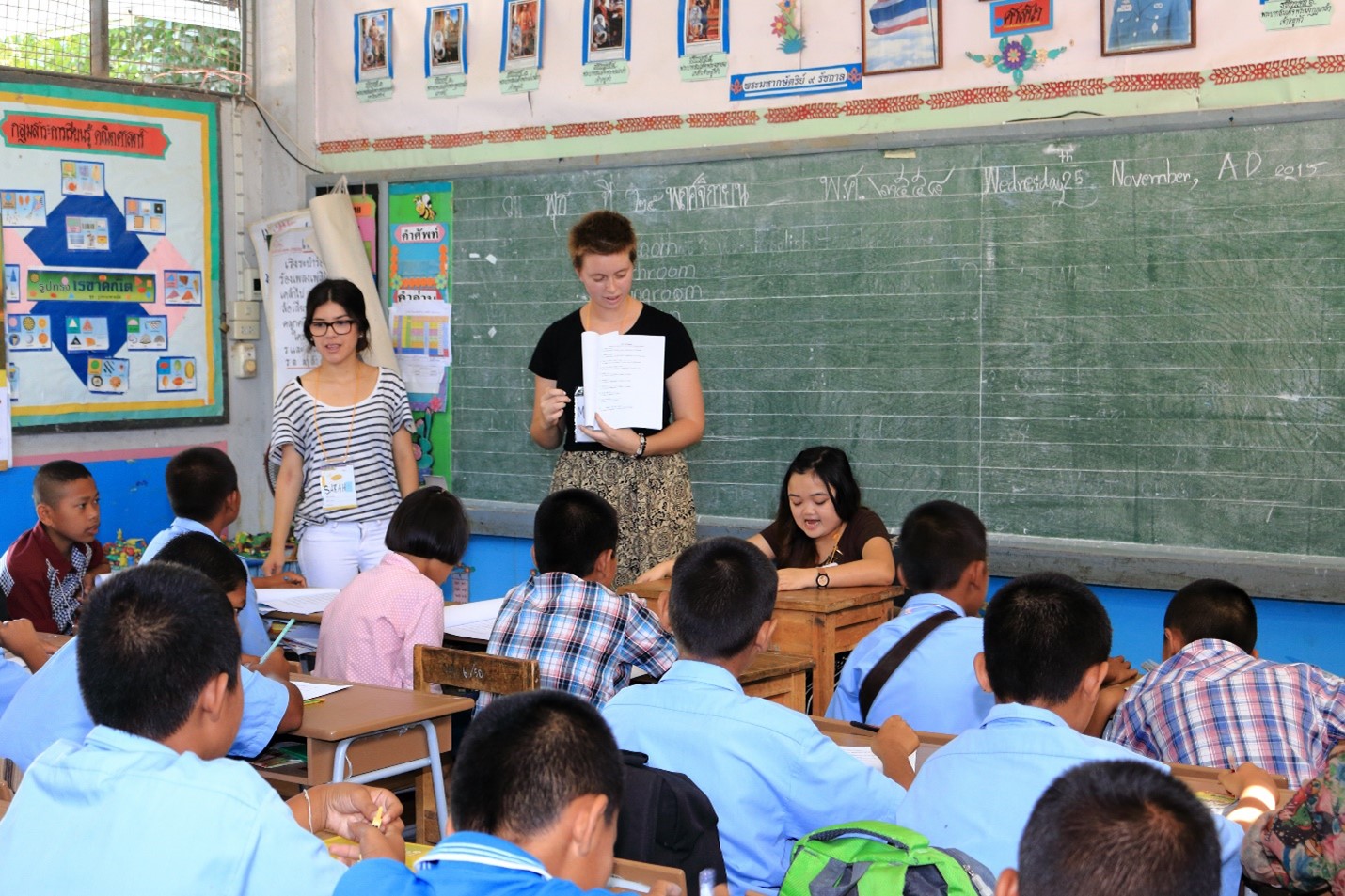 Photo of two teachers and students in a classroom setting