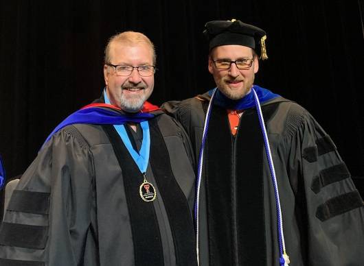 Dr. Malcom Brownell celebrating his graduation with his faculty advisor, Dr. Ian Lertora