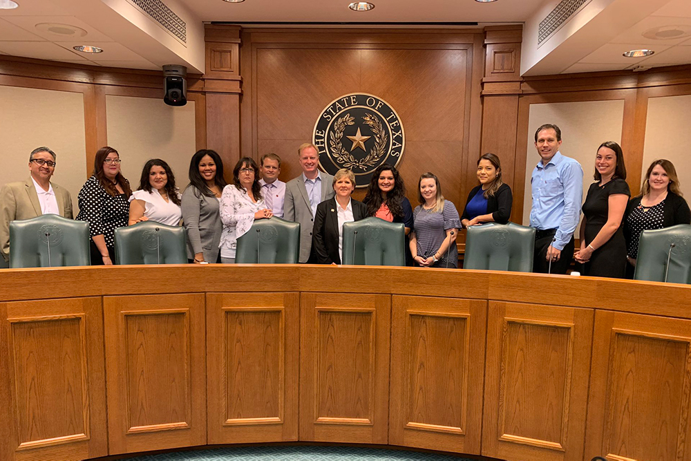 Members of the Texas Education Policy Fellowship Program pose with Harrison Keller, the Texas higher education commissioner