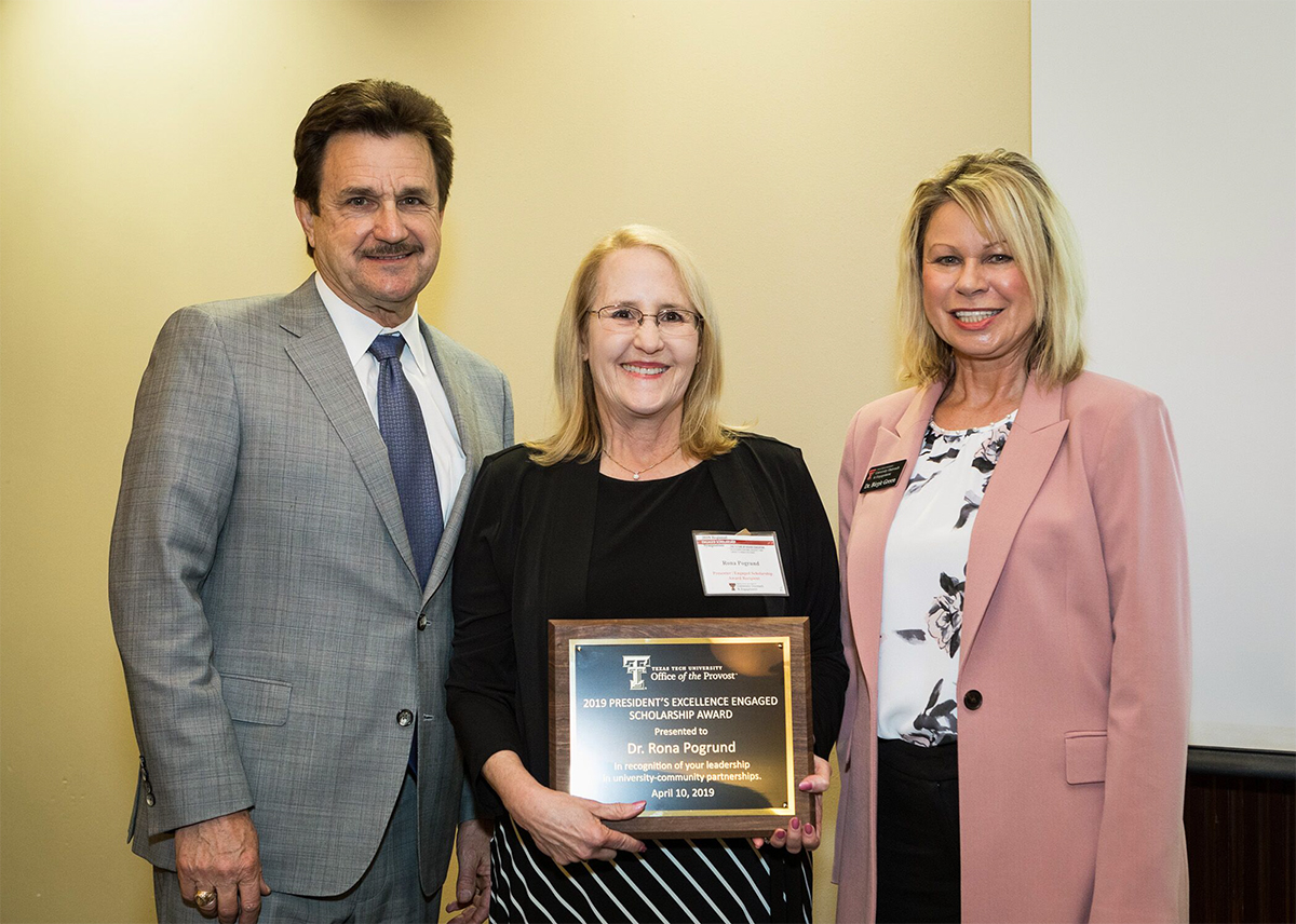 Rona Pogrund poses with Texas Tech University President Lawrence Schovanec and Birgit Green, director of University Outreach and Engagement at Texas Tech.