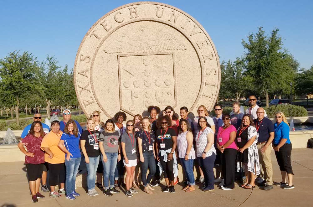 Cohort 4 of the Texas Tech Principal Fellows Program posing in front of the Texas Tech University Seal