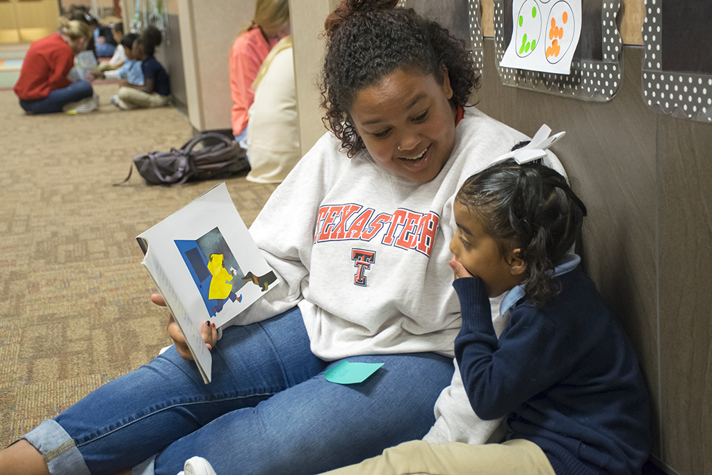 A student in Texas Tech University's "Early Literacy in the School Setting" course reads aloud with an Ervin Elementary School student