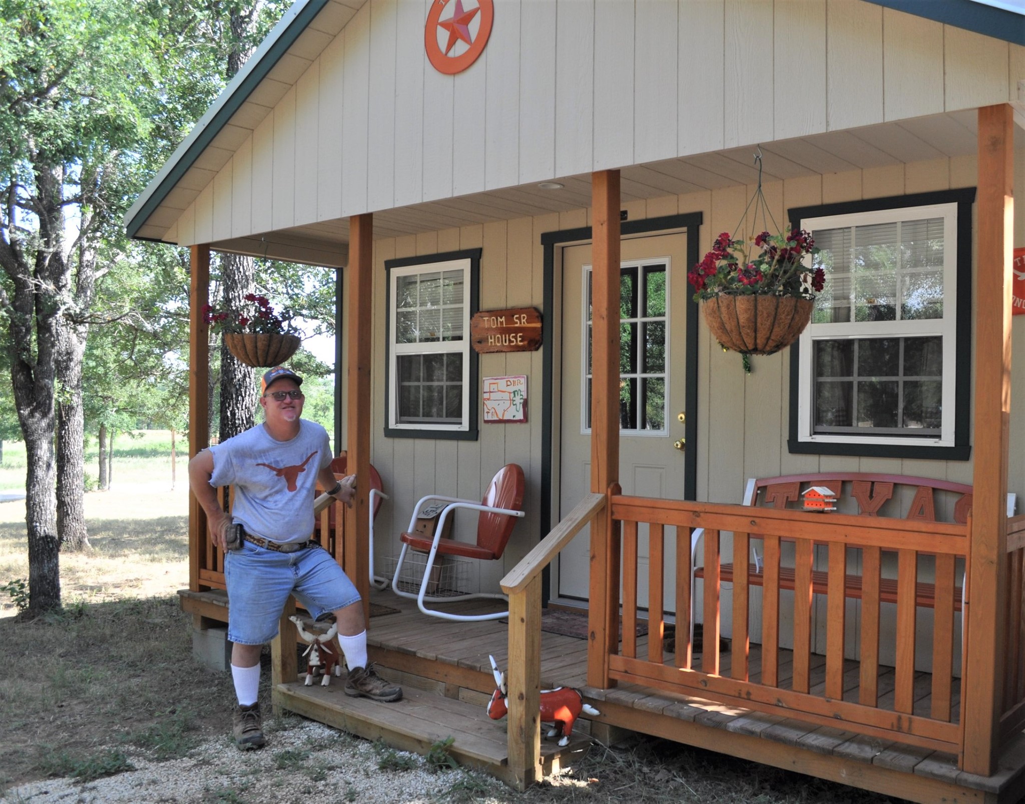 A Down Home Ranch resident stands outside his microhome.