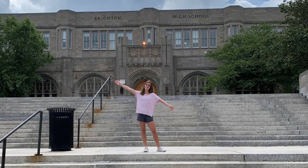 City Year student in front of Brighton High School in Boston