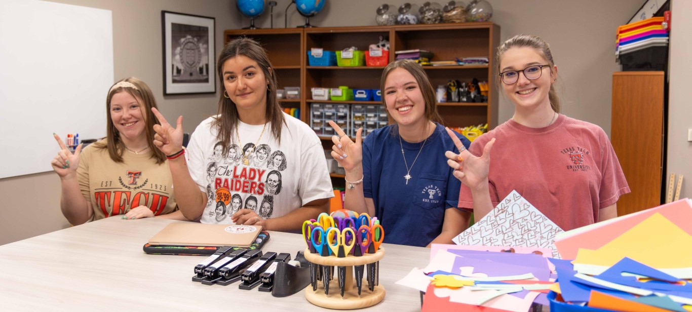 Four TechTeach students in the Cutting Edge, giving the TTU Guns Up sign