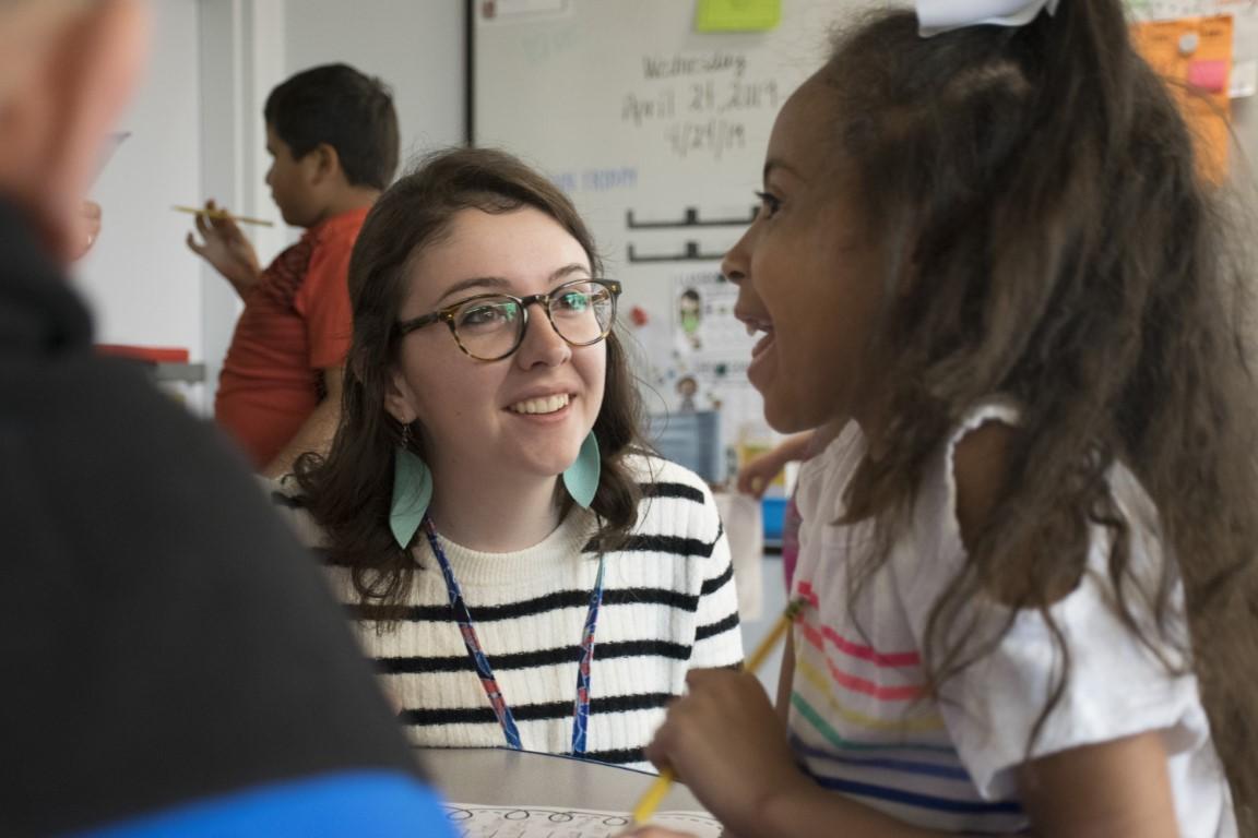 TechTeach teacher candidate with student in elementary classroom