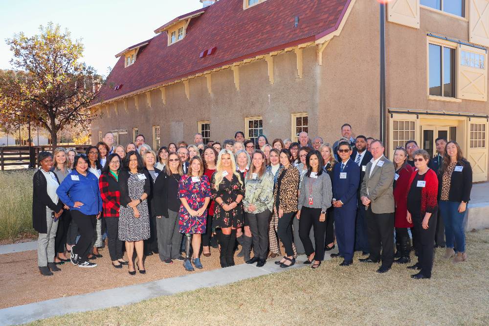 A group photo of 2021 winter summit attendees outside the TTU dairy barn