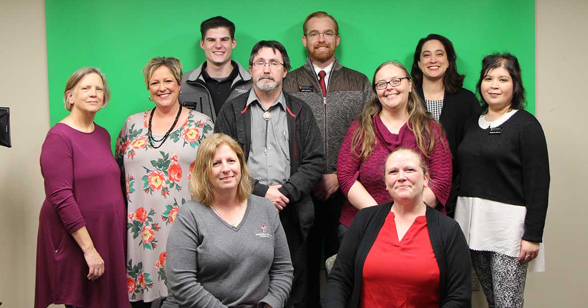 Image of all the members of th eLearning & Academic Partnerships Instructional Design team standing next to one another.