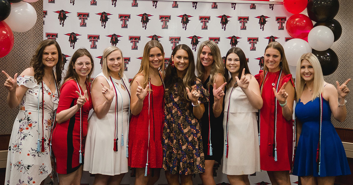 First Education Graduates from TTU Waco pose with guns up hands.