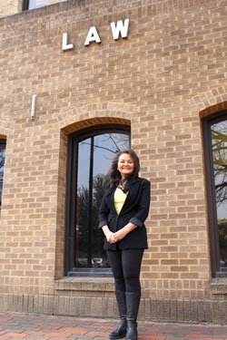 Dr. Victoria Sutton standing outdoors in front of the Texas Tech University School of Law building.