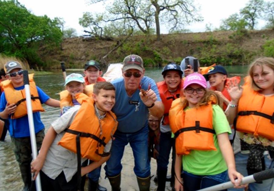 Trent ISD students search for butterflies by the Llano River.