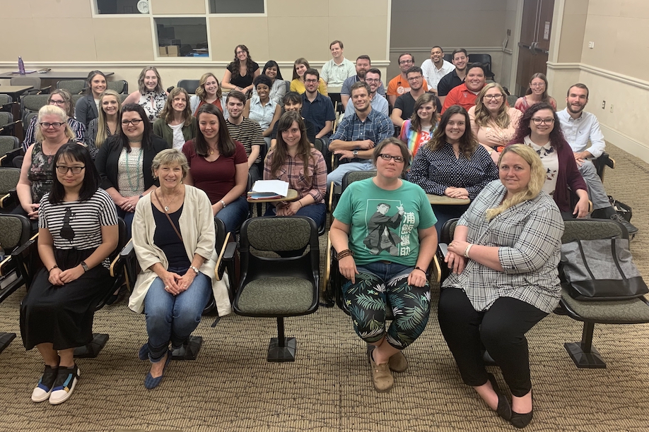 A group of teachers sitting together in auditorium seating