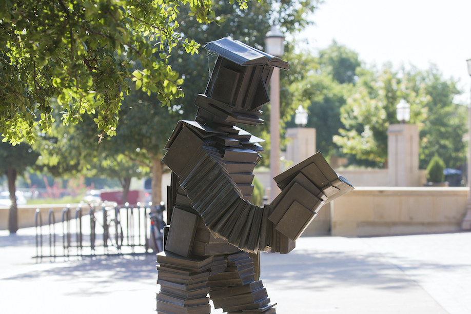 statue of human made out of books