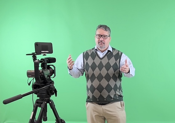 Dr. Geoffrey Sauer in front of a green screen