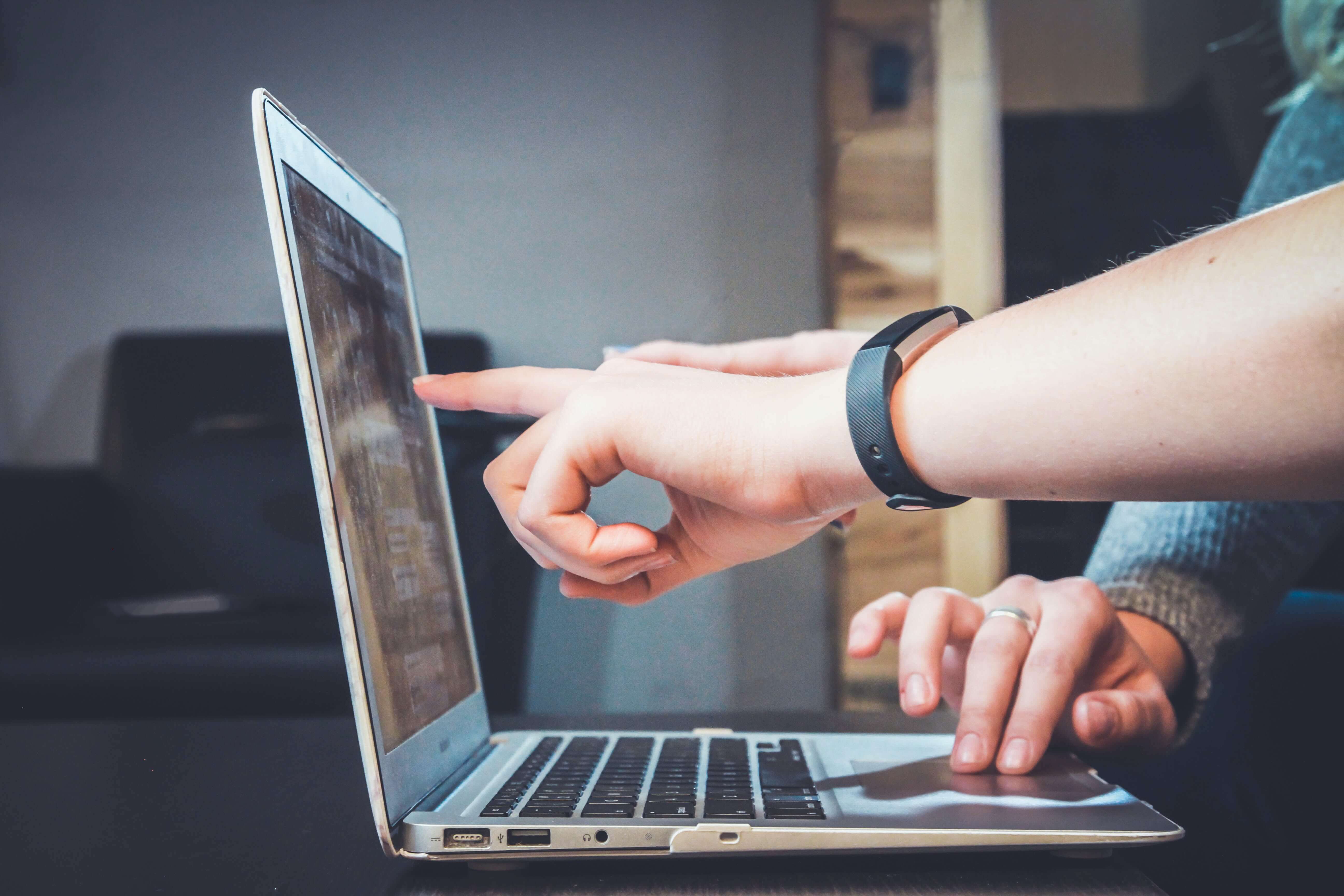 Two people working on computer