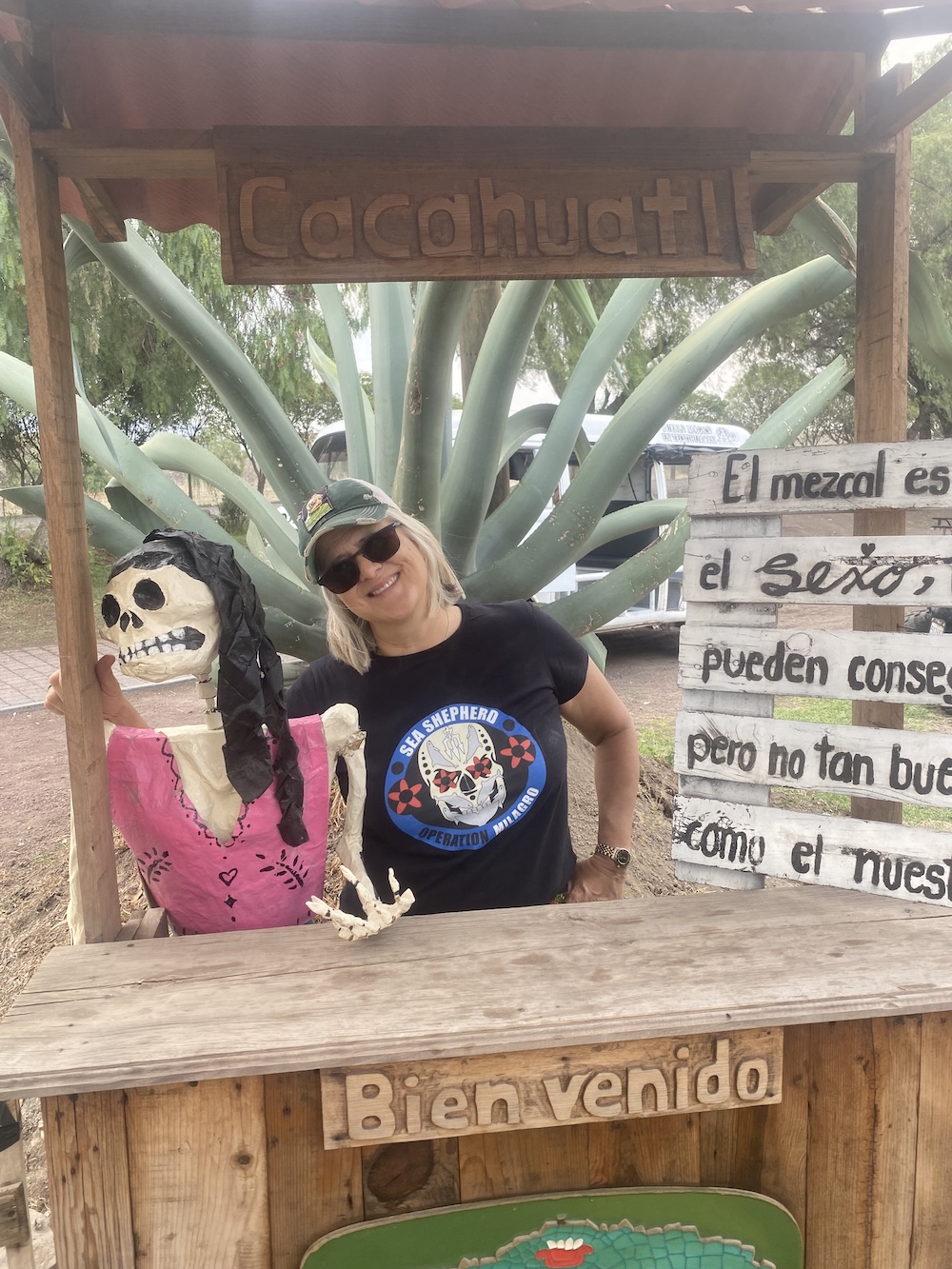 Dr. Barrera next to a mache skeleton at a booth