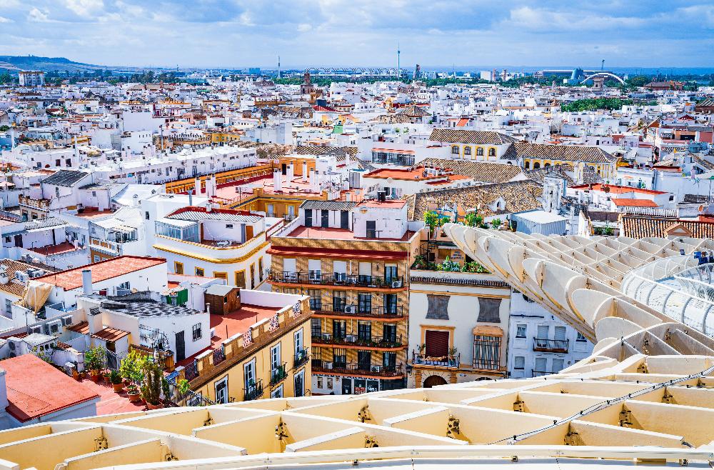 aerial view of Sevilla, featuring colorful houses and a blue sky