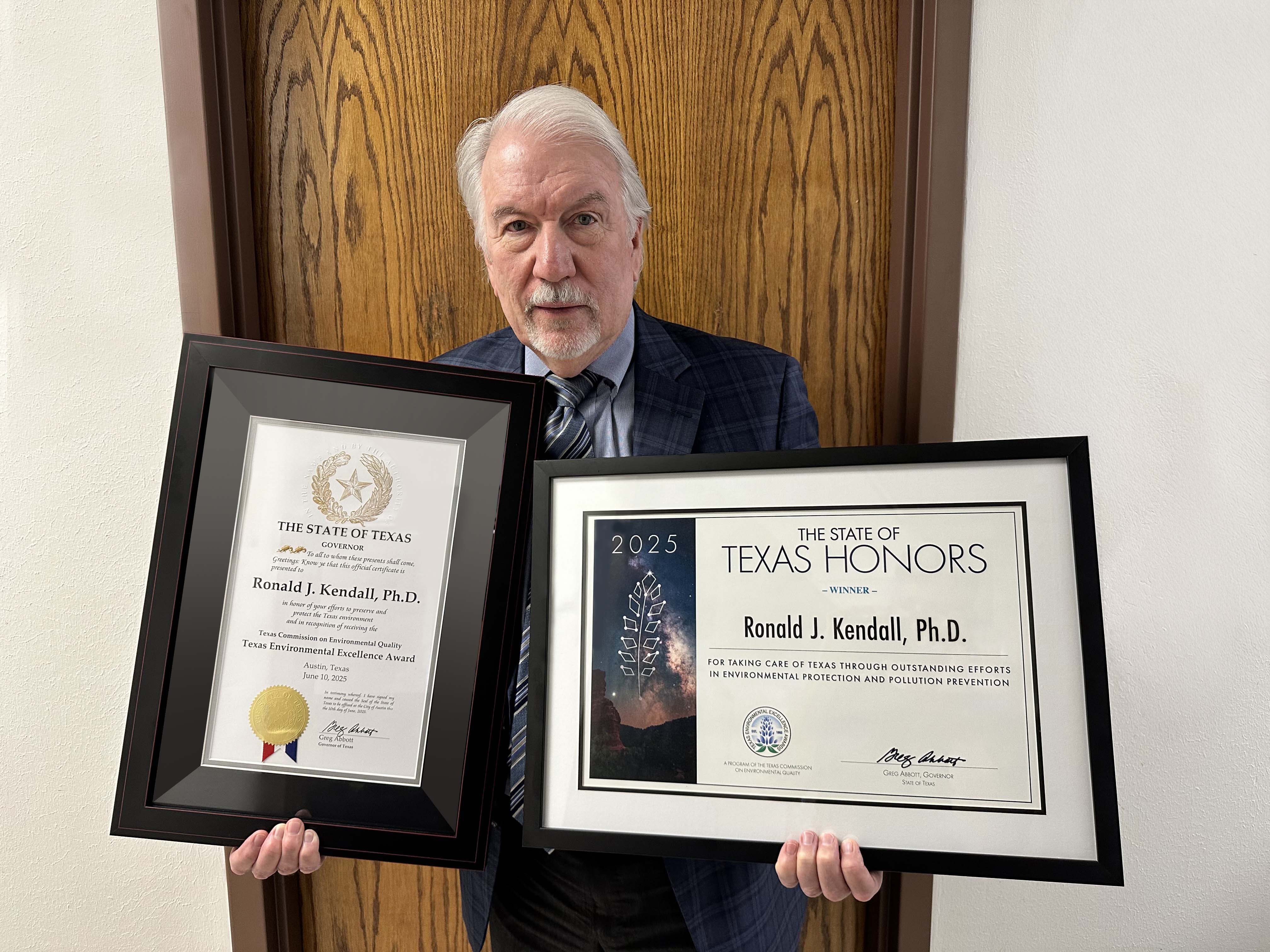 Ron Kendall Ph.D. holding his TEEA Awards Texas Tech University, Environmental Toxicology Professor, Ron Kendall Ph.D. holding his TEEA Awards