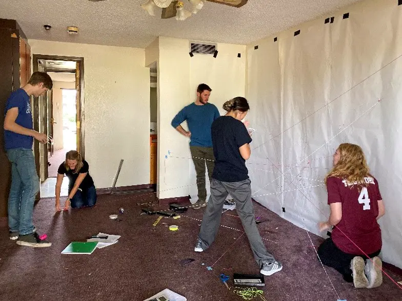 Students learning forensic science techniques in a mock crime scene