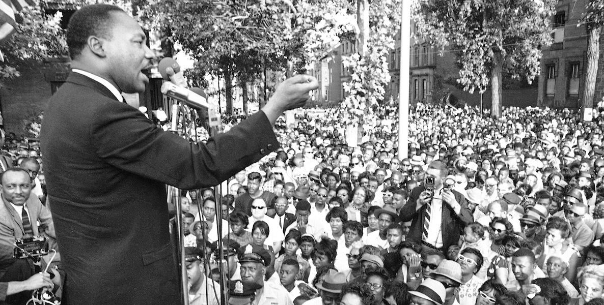 Martin Luther King Jr. speaking to a large crowd of people