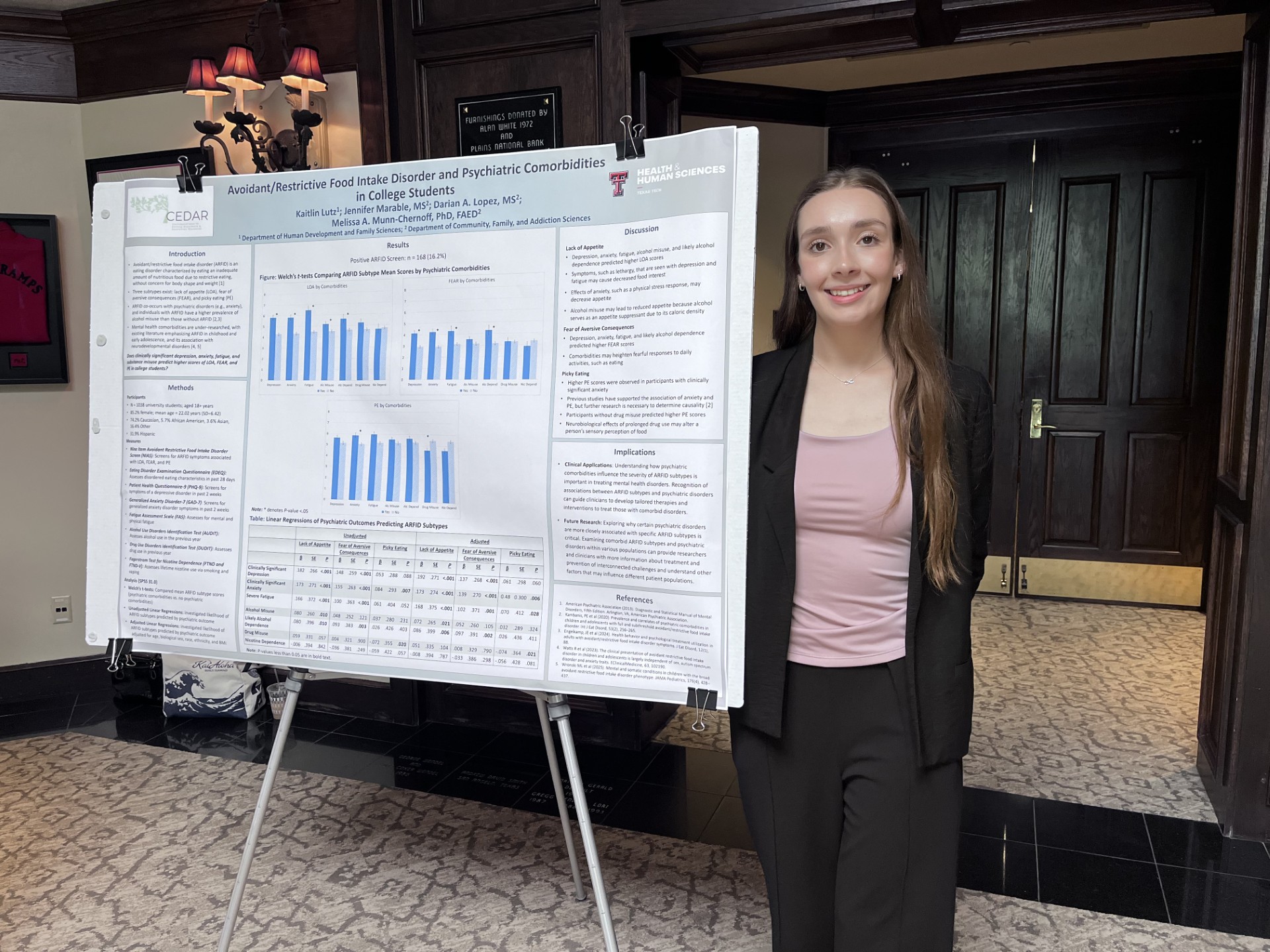 Kaitlin next to McKenzie Lectureship poster
