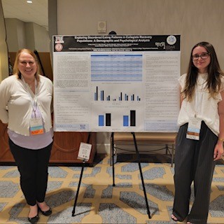Trinity and Dr. Munn-Chernoff next to ARHE poster
