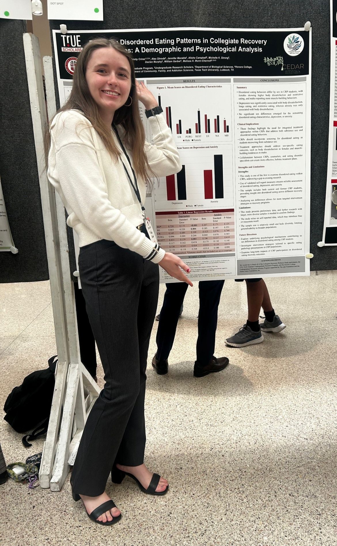 Trinity next to URC poster