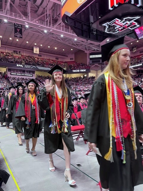 Trinity walking at graduation