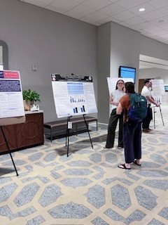 Trinity discussing ARHE poster