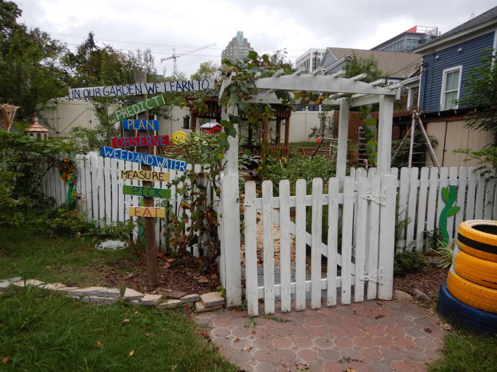 Image of an entry to an outdoor learning environment with a gate.