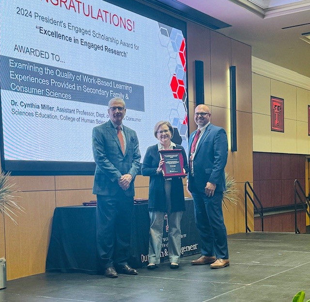 Miller accepts her Award