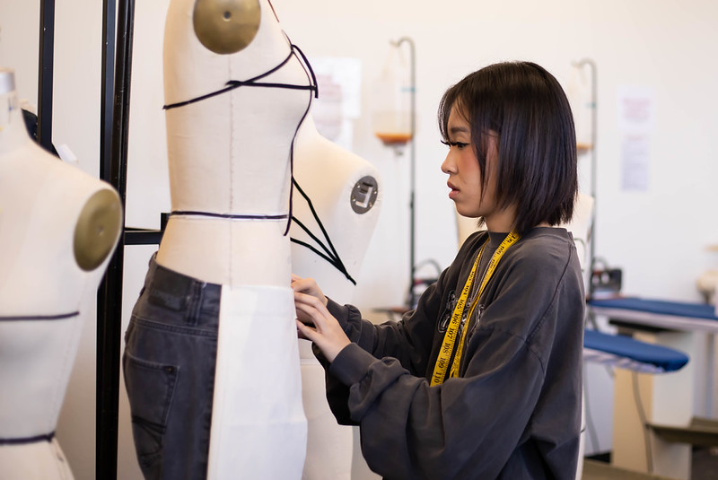 apparel design student fitting pants on dressform