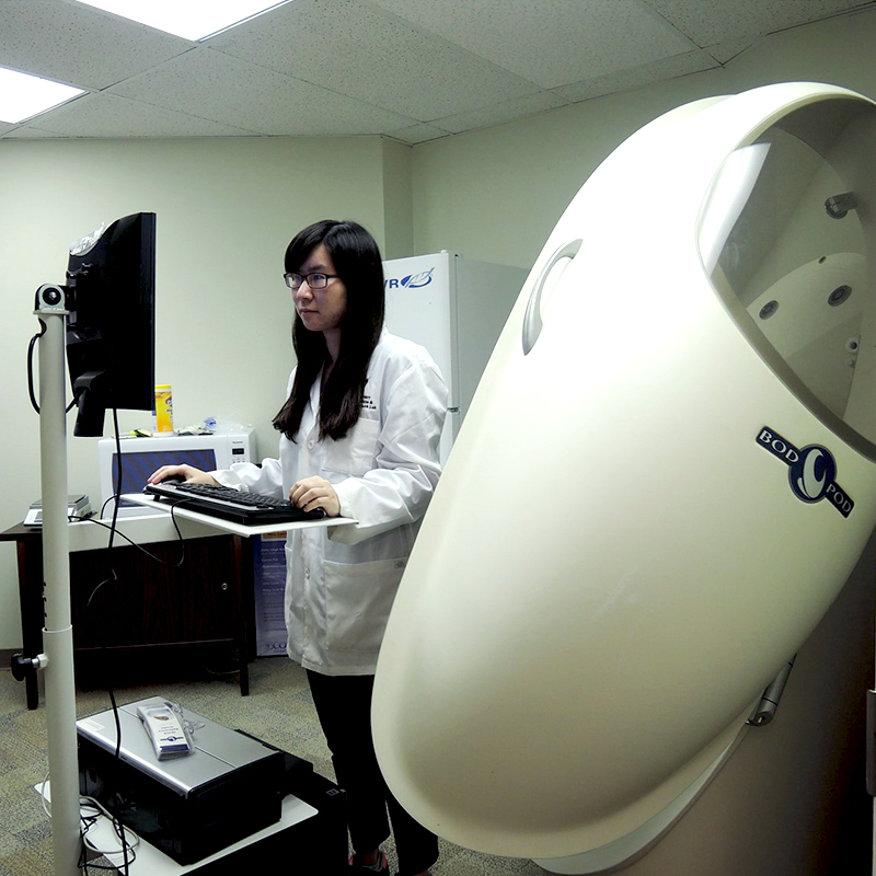 Photo of student working on Bod Pod Gold Standard Body Composition testing at NMHI.