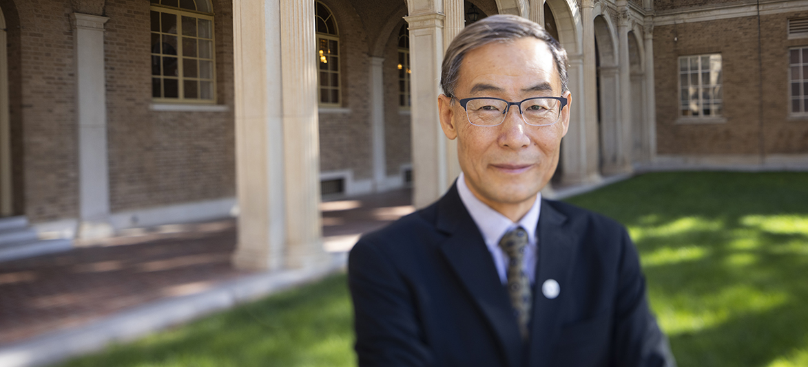 CIO Dr. Lin Zhou posing outside of the Administration building at Texas Tech University.