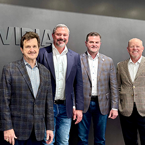 Chancellor Creighton, President Schovanech, Cody Campbell, and Dustin Womble, pose in front of a NVIDIA logo.