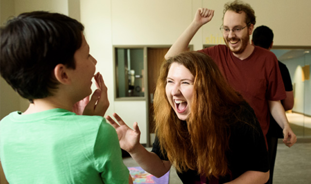 TTU DIA faculty with a minor student laughing and congratulating
